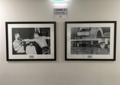 Photograph of the lift lobby of Festival Towers showing two framed hpotographs of events that took place at the Festival Hall.